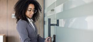 woman is opening the door using her phone